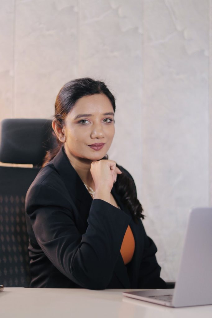Sakshi Jethwani at her desk in a black blazer