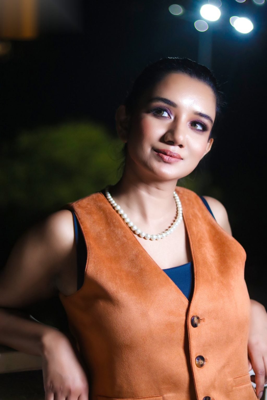 Sakshi Jethwani in a tan waistcoat, evening light