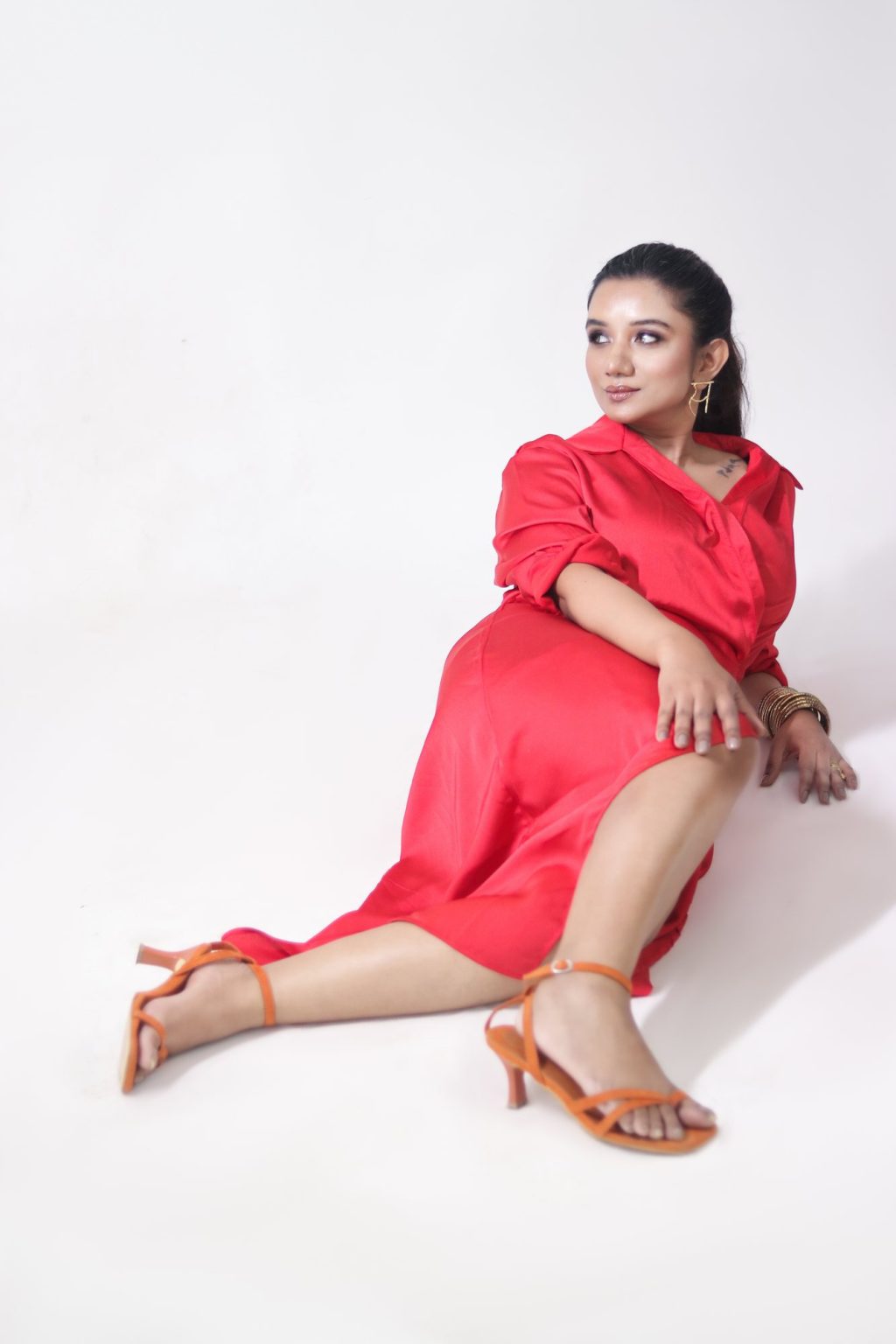 Sakshi Jethwani seated in a red dress